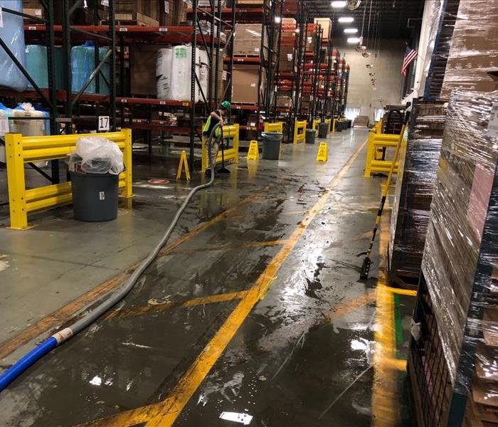 flooded water pooled on floor of large warehouse