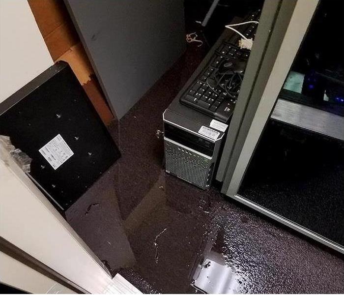 water soaked carpet and electronics after commercial water damage disaster